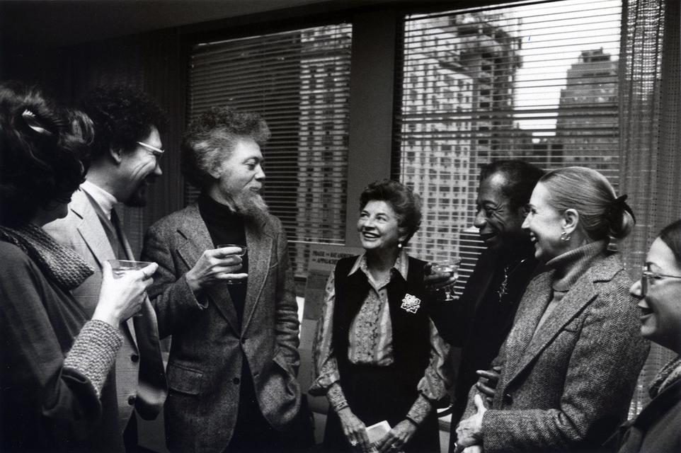 Benny Andrews (center), with brother Raymond Andrews (left) and James Baldwin (right), celebrating the awarding of the first James Baldwin Prize for Fiction to Raymond’s *Appalachee Red* (1977), Dial Press headquarters, New York, 1979.