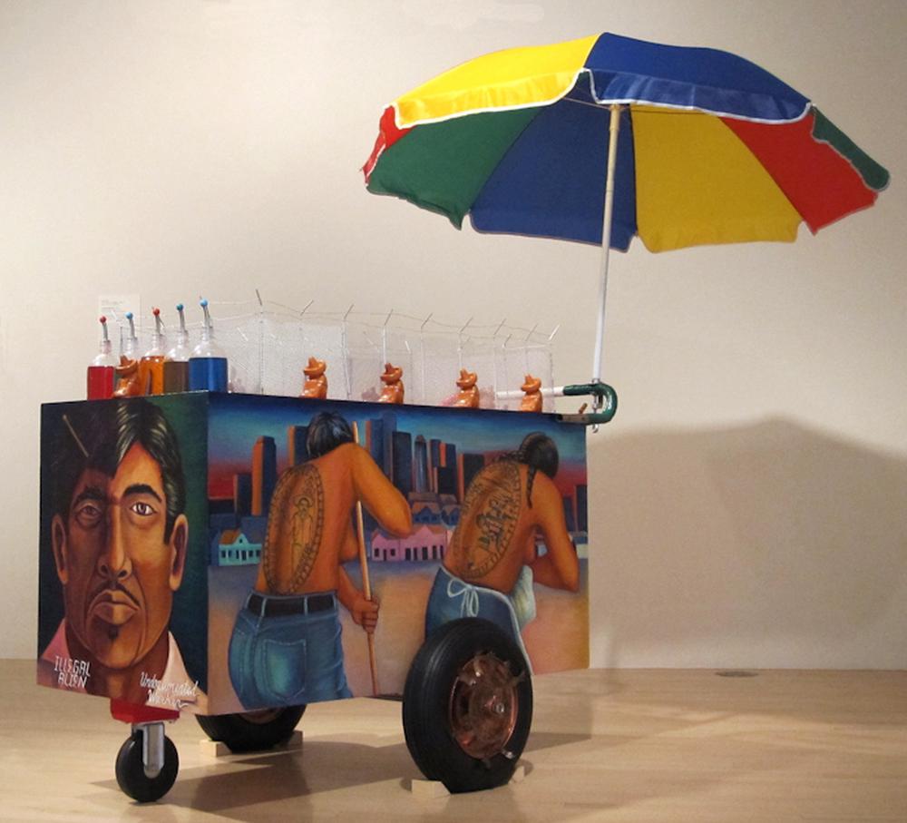 Installation image of a vendor cart painted and staged in a gallery space