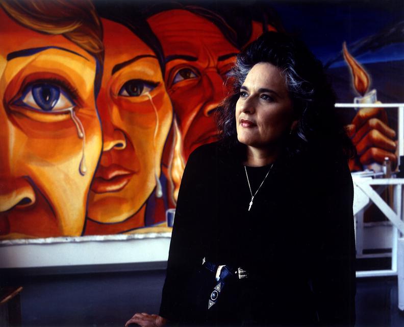 Portrait of Judy Baca with *Triumph of the Hearts*, 1990. Acrylic on canvas, one of nine panels: each 10 x 30 feet.