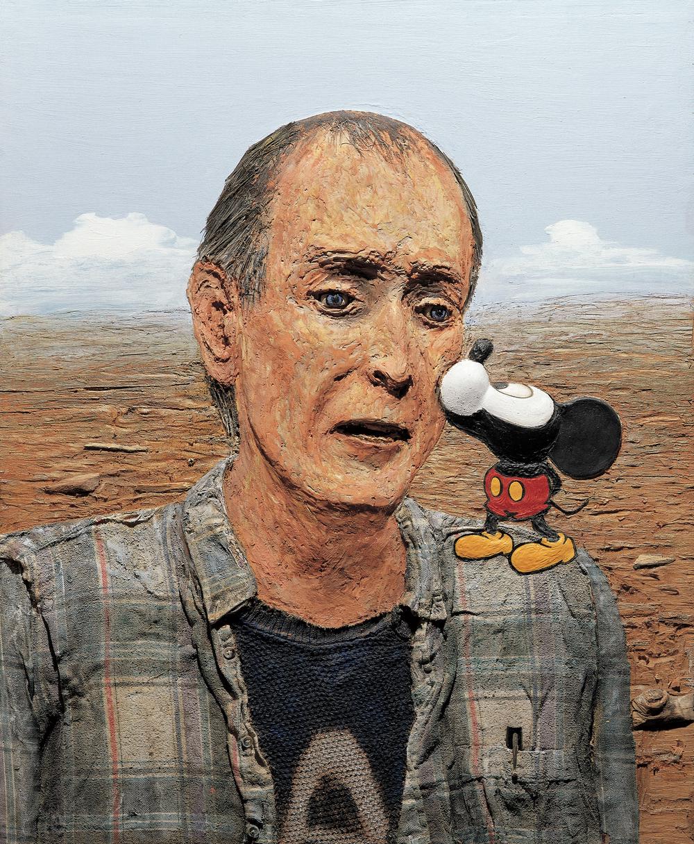 man being kissed on the left cheek of his face by a shoulder sized mickey mouse character