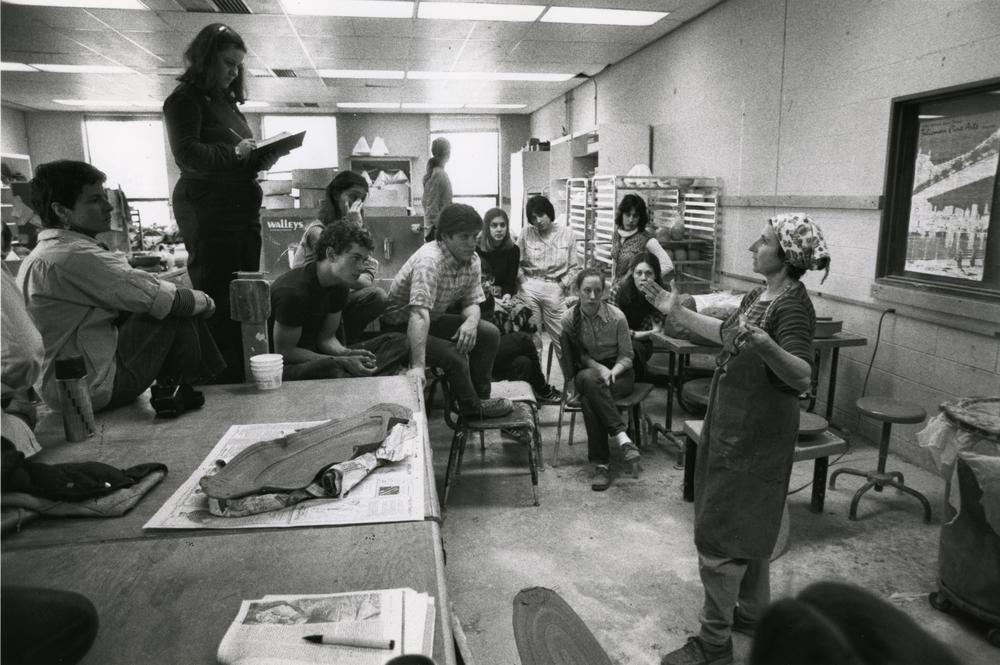 artist in studio classroom setting lecturing students taking notes
