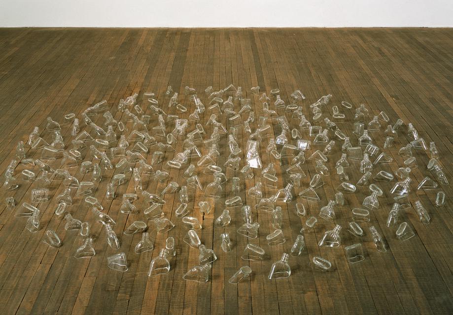 Mona Hatoum, *Drowning Sorrows*, 2001–02. Glass bottles, 4 x 98 1/2 x 98 1/2 inches.