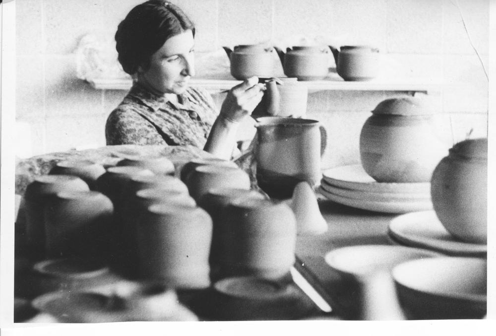 artist working on ceramic pieces in studio